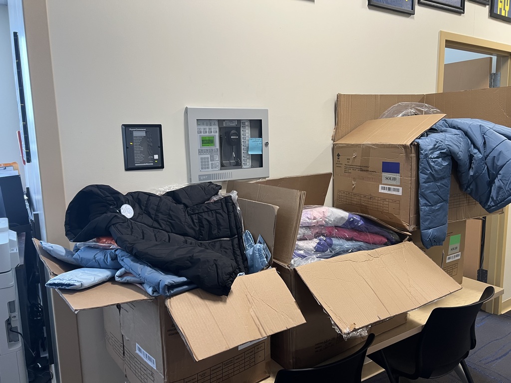 Four big boxes filled with coats that Koos For Kids donated to Olympia Brown School.