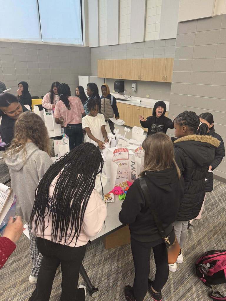 Students purchasing items from their classmates' storefronts. 