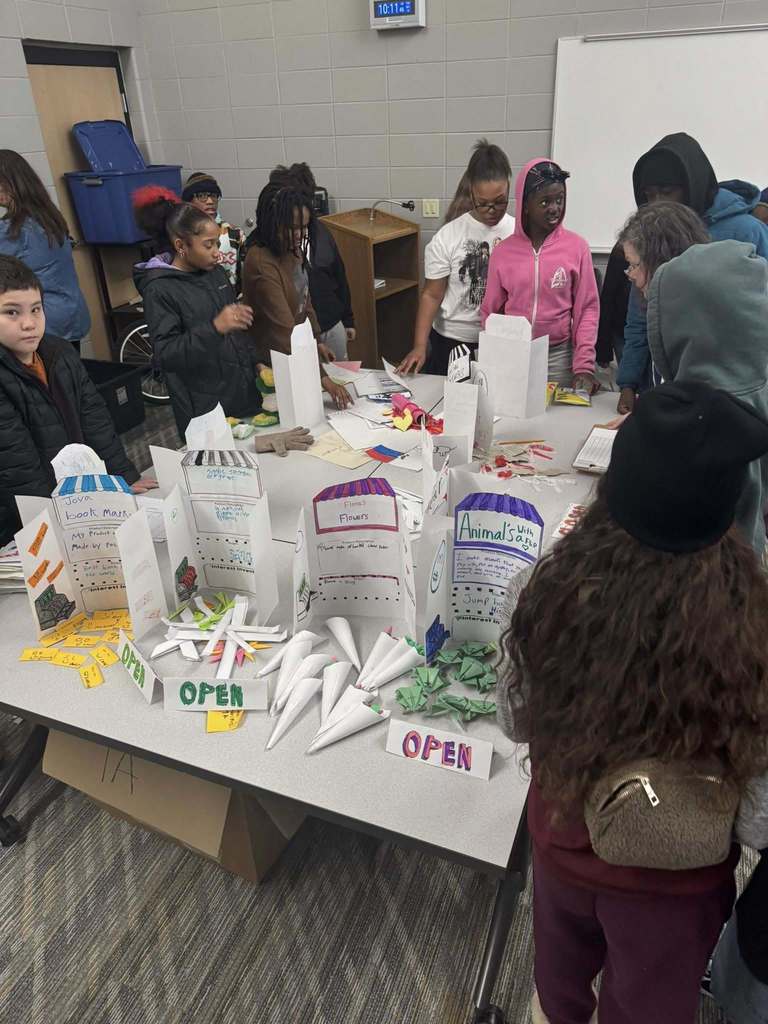 Students purchasing items from their classmates' storefronts. 