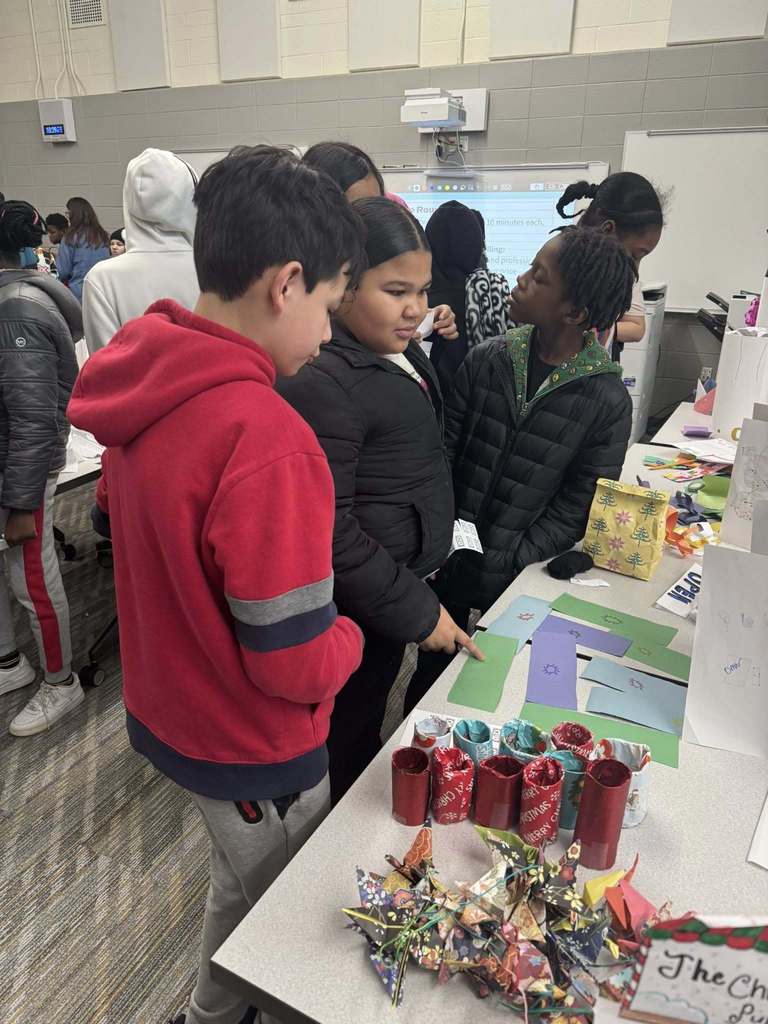 Students purchasing items from their classmates' storefronts. 