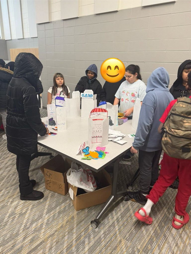 Students purchasing items from their classmates' storefronts. 