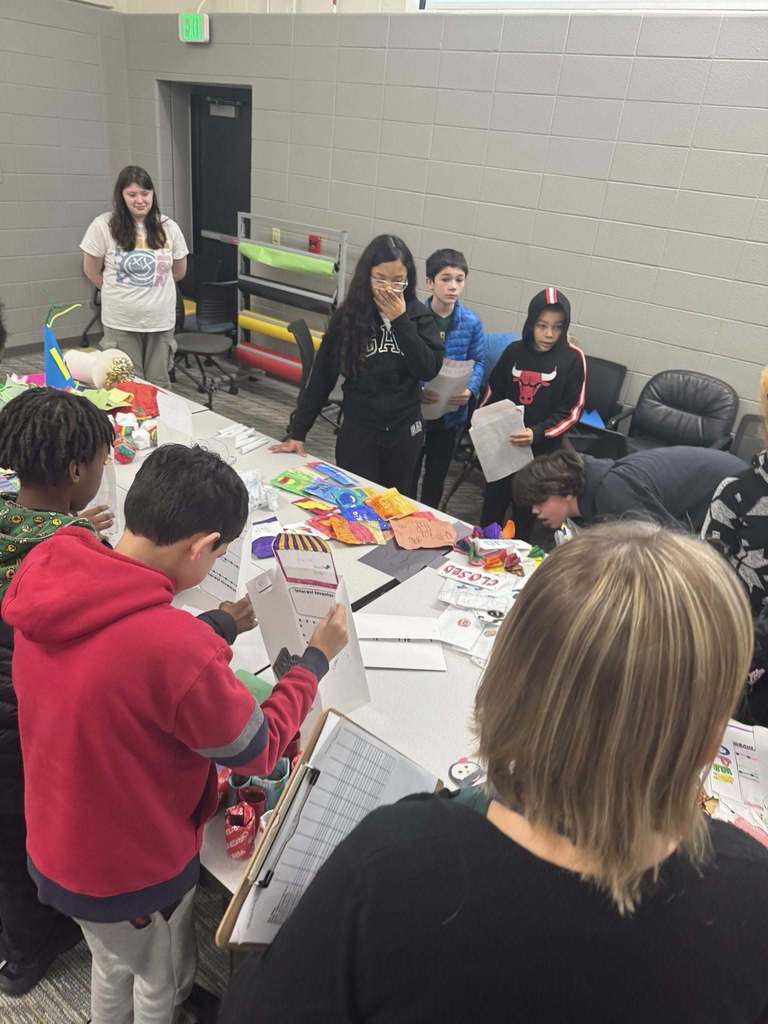 Students purchasing items from their classmates' storefronts. 