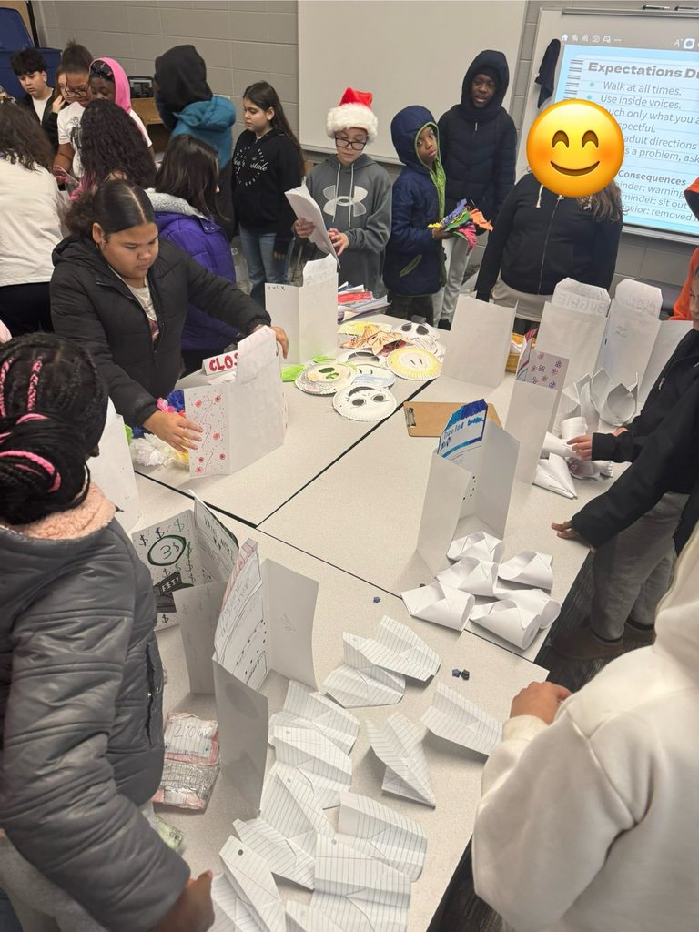 Students purchasing items from their classmates' storefronts. 