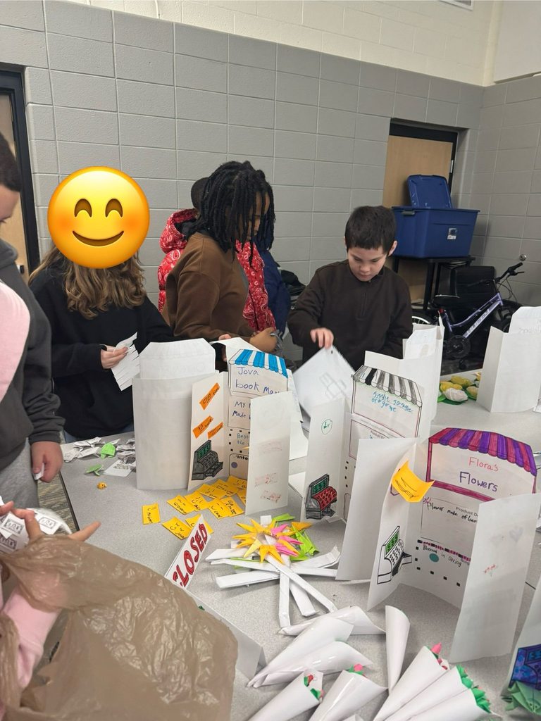 Students purchasing items from their classmates' storefronts. 