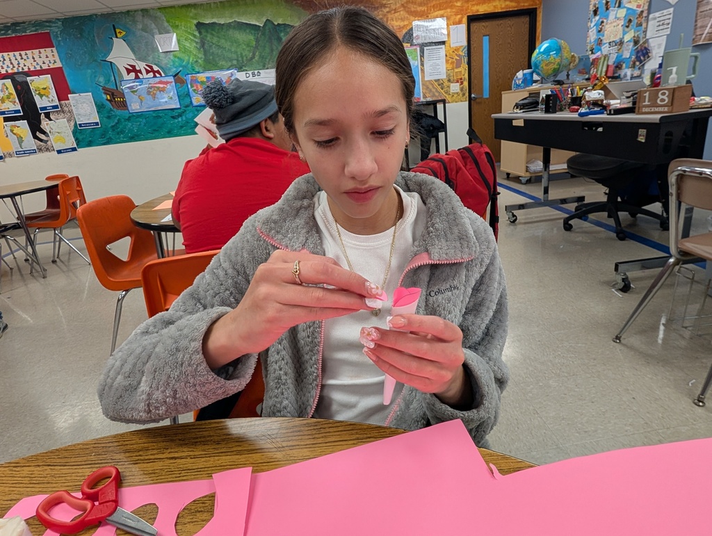 A female student handcrafts a product for her marketplace.