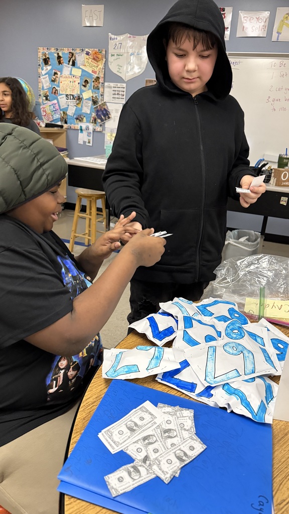 After extensive market research, it was found that "squishy 6-7s" had potential to be a top selling product. A male student sells one of his handmade "squishy 6-7s" to another male student.