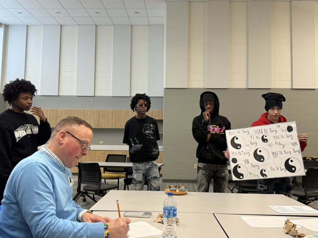 Students presenting their cupcake designs to the judging panel.