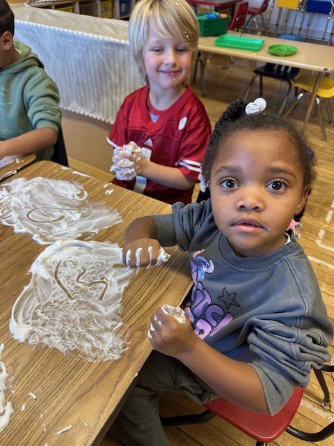 Students exploring lettters using shaving cream.