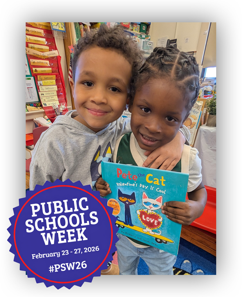 Two kindergarten students. One of them is holding a Pete the Cat children's book.