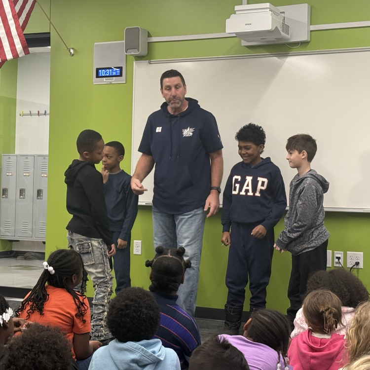 Marcus Hanel holding baseball with students