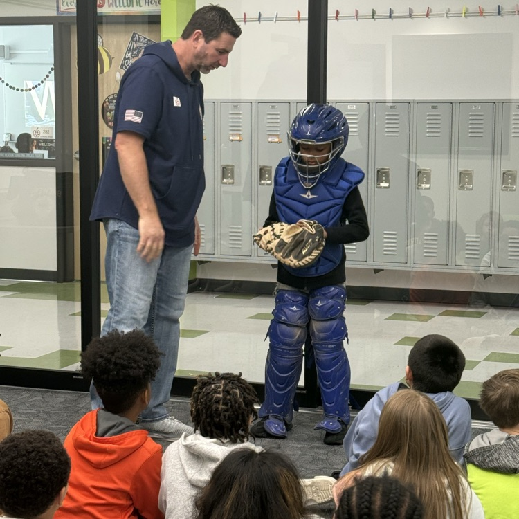 Marcus Hanel demonstrating catcher equipment with student