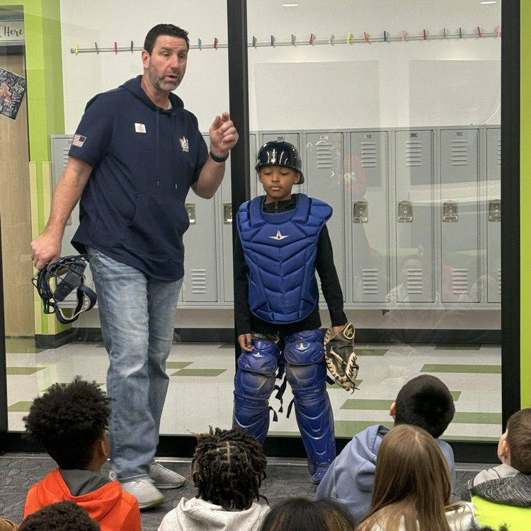 Student wearing catcher’s equipment with Marcus Hanel