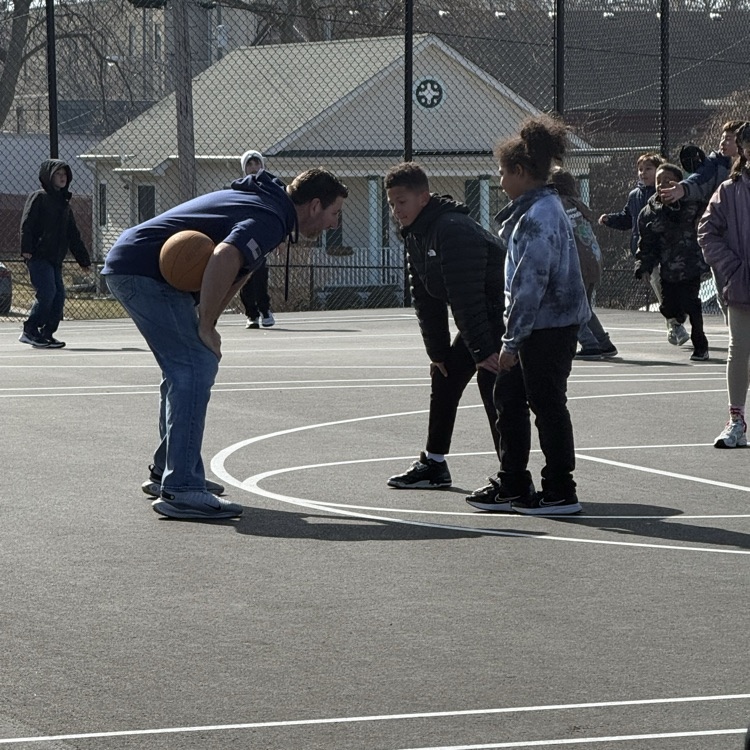 Marcus Hanel being guarded by 2 students.