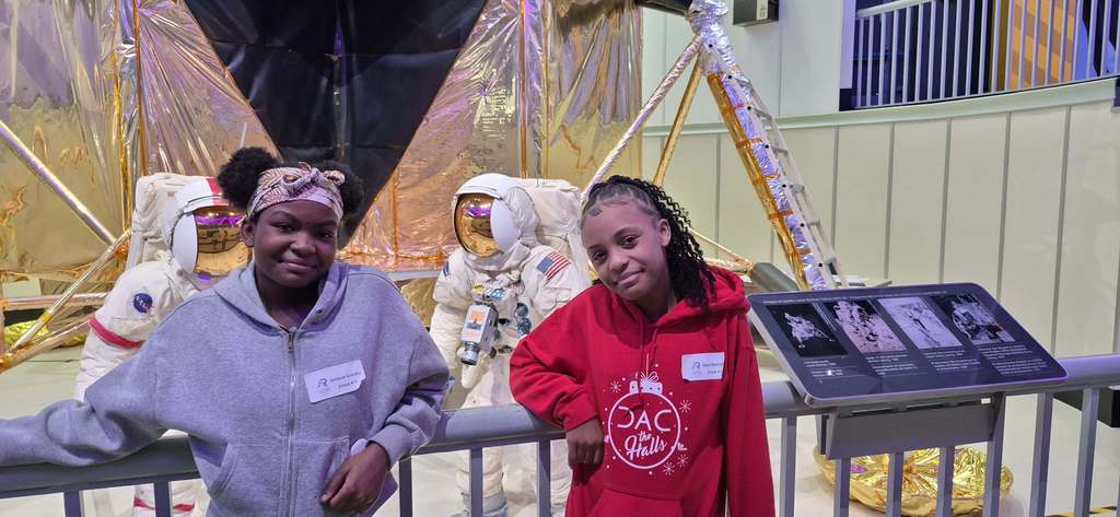Students looking at an astronaut exhibit.