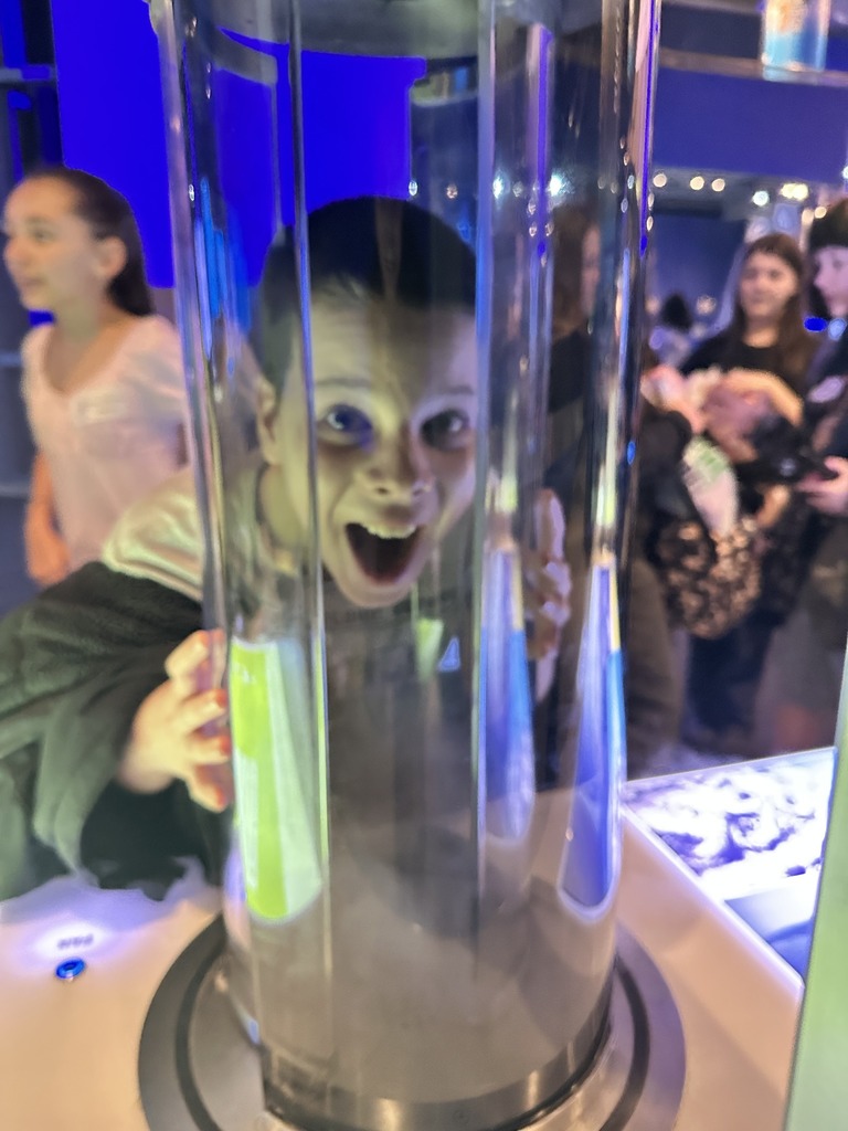 A boy looking through a water tube.