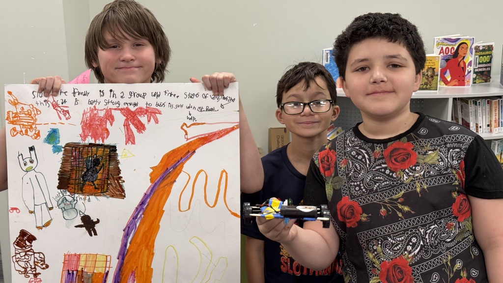 Three Julian Thomas students pose for a photo after their presentation