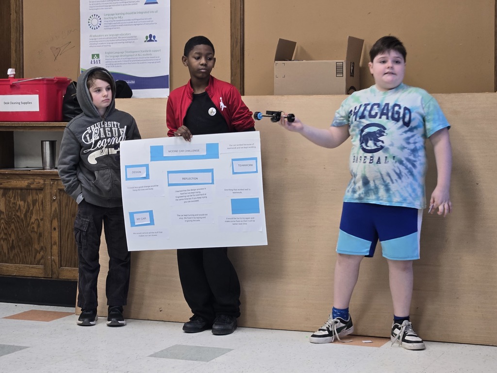 Three Mitchell students giving their presentation