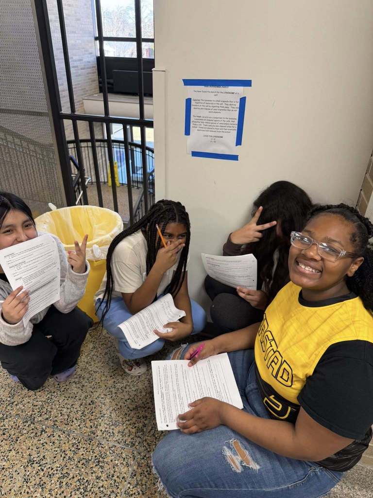 A group of students pose for a picture after they have found a clue.