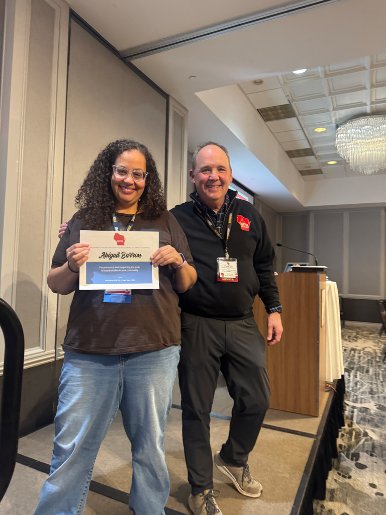 Abigail Barron receiving her award from the Wisconsin Council on the Social Studies.