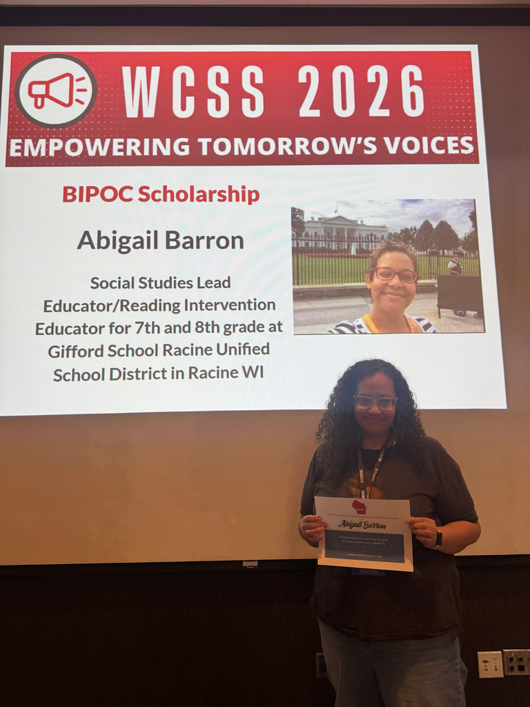 Abigail Barron receiving her award from the Wisconsin Council on the Social Studies.