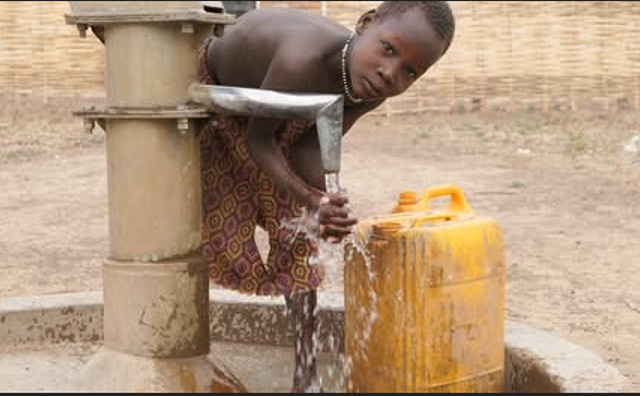 Boy getting water from well
