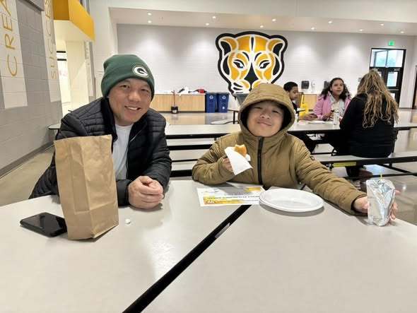 5th grade student shares breakfast with his dad