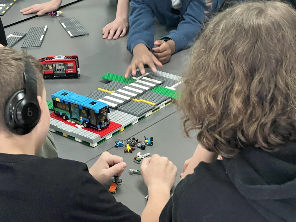 Students participate in a LEGO building activity for an Urban Planning presentation.