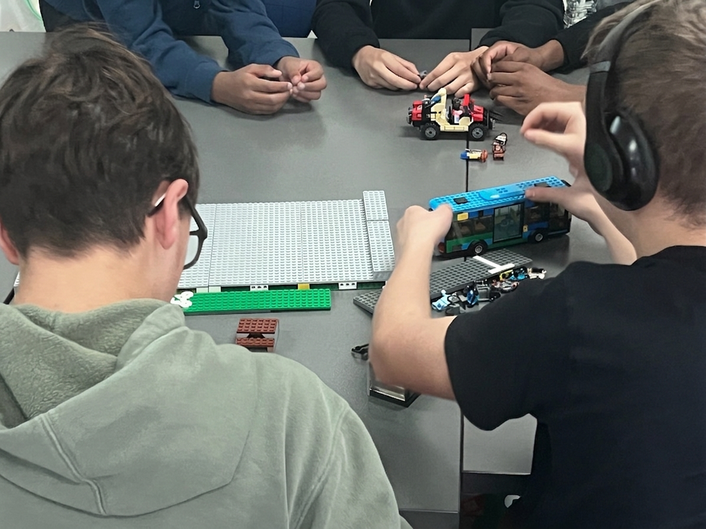 Students participate in a LEGO building activity for an Urban Planning presentation.