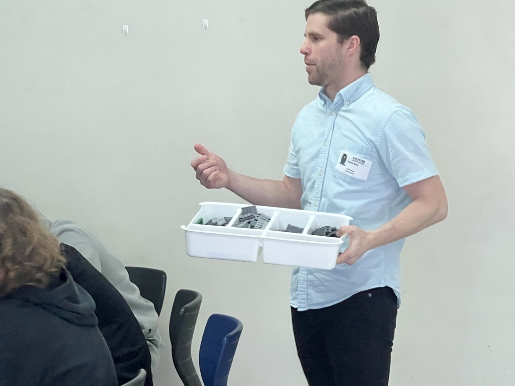 Kaleb Kutz of the Southeastern Wisconsin Regional Planning Commission speaks to REAL School students.