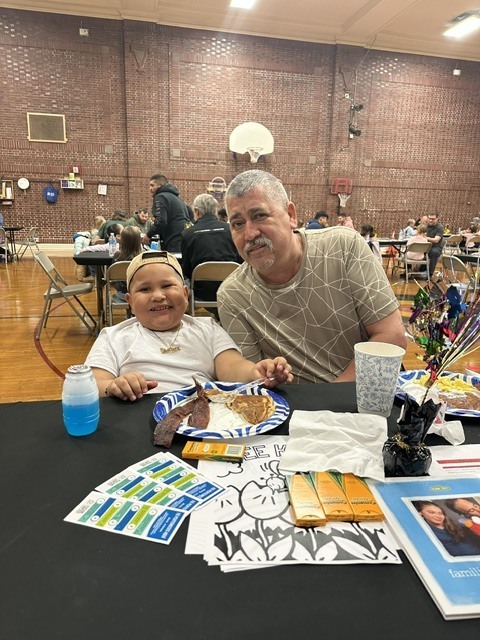 Grandfather and grandson enjoying breakfast.