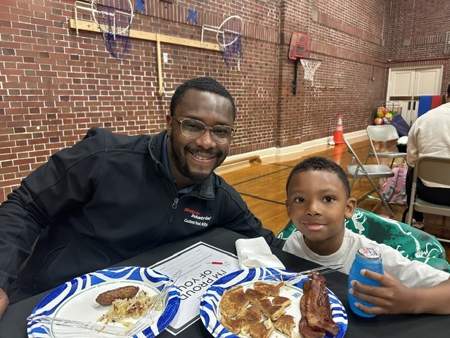 Father and son enjoying breakfast.