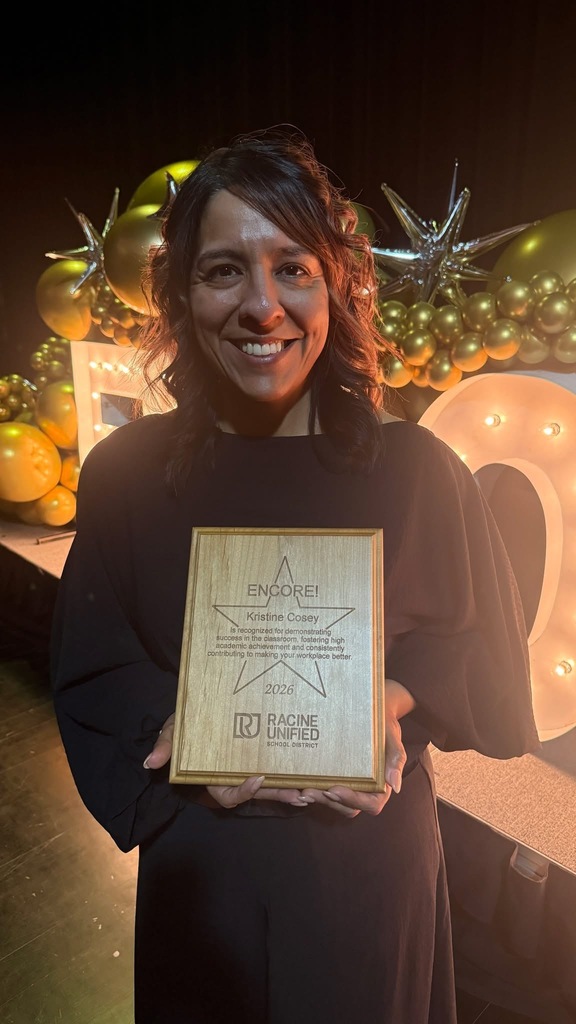 Woman holding plaque.