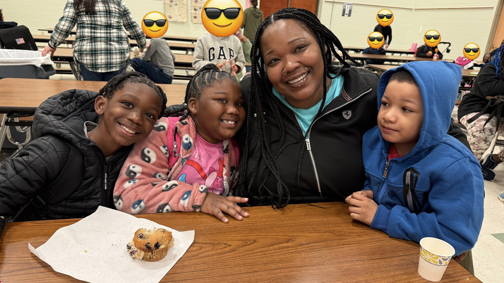 A mother and her children, enjoying breakfast.