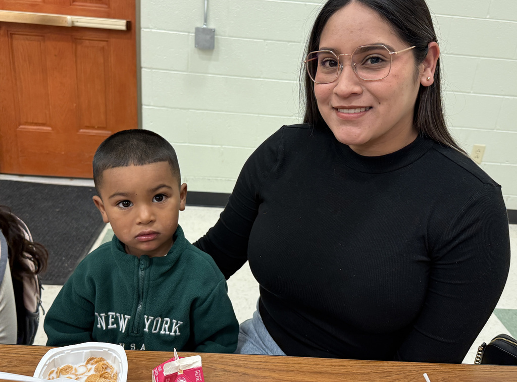 A mother and her child, enjoying breakfast.