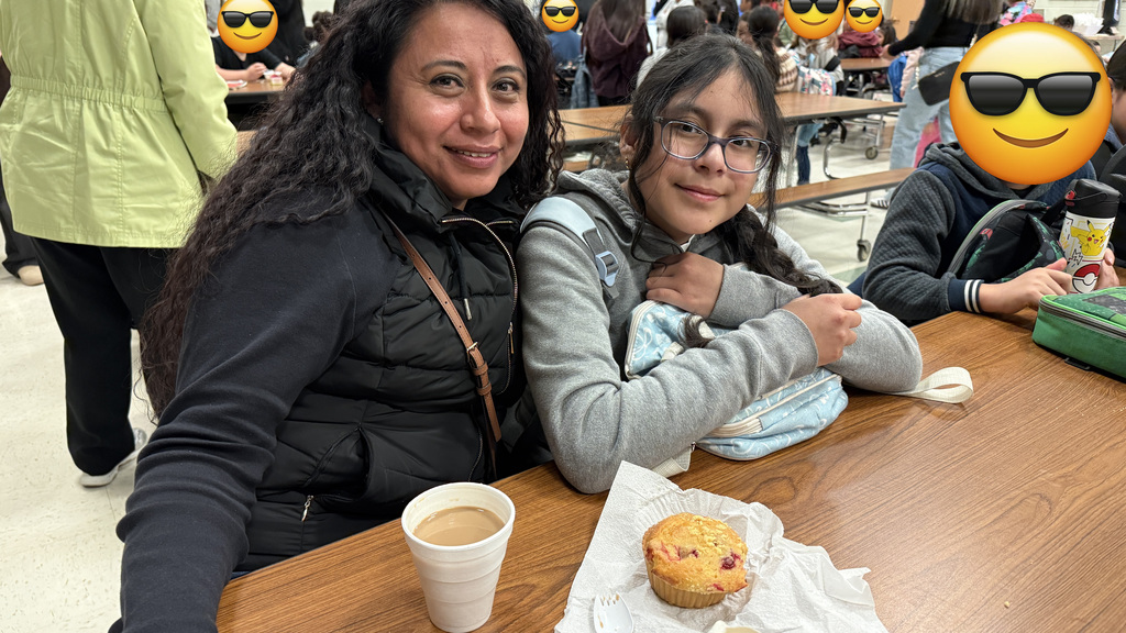 A mother and her child, enjoying breakfast.