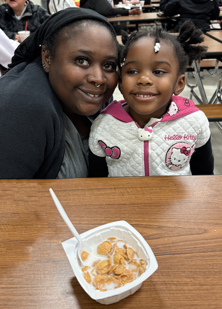 A mother her child enjoying breakfast.