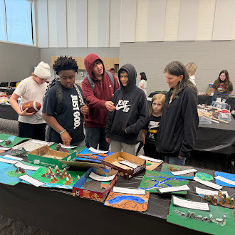 6th grade students walk some community members through the Latin America museum exhibit.