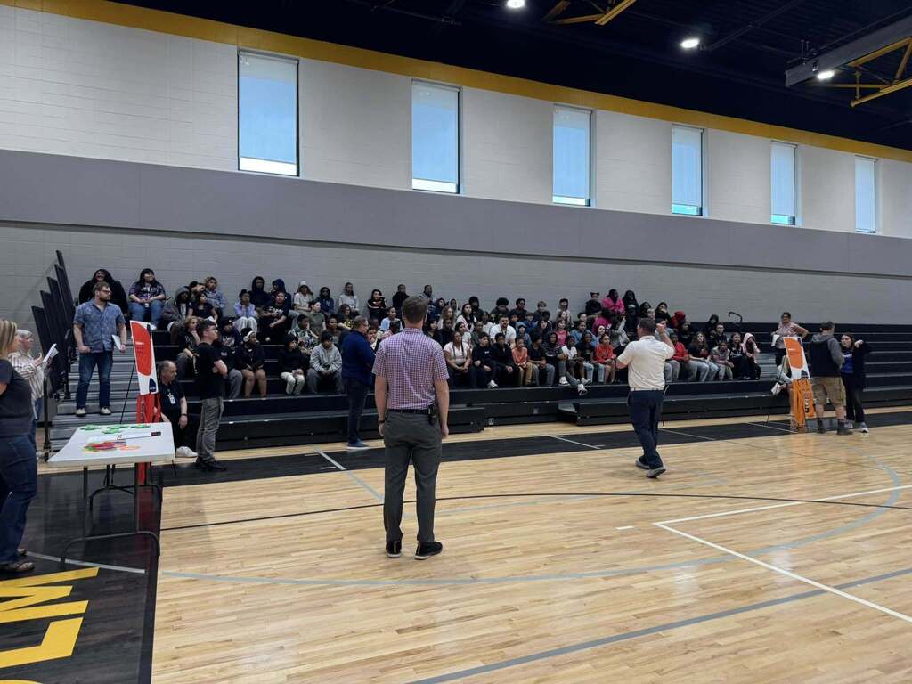 Mr. Paproth addresses the sixth grade class at the Everfi celebration in the elementary gym.