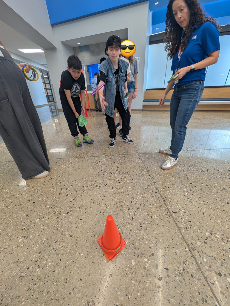 A male student playing a ring toss game.