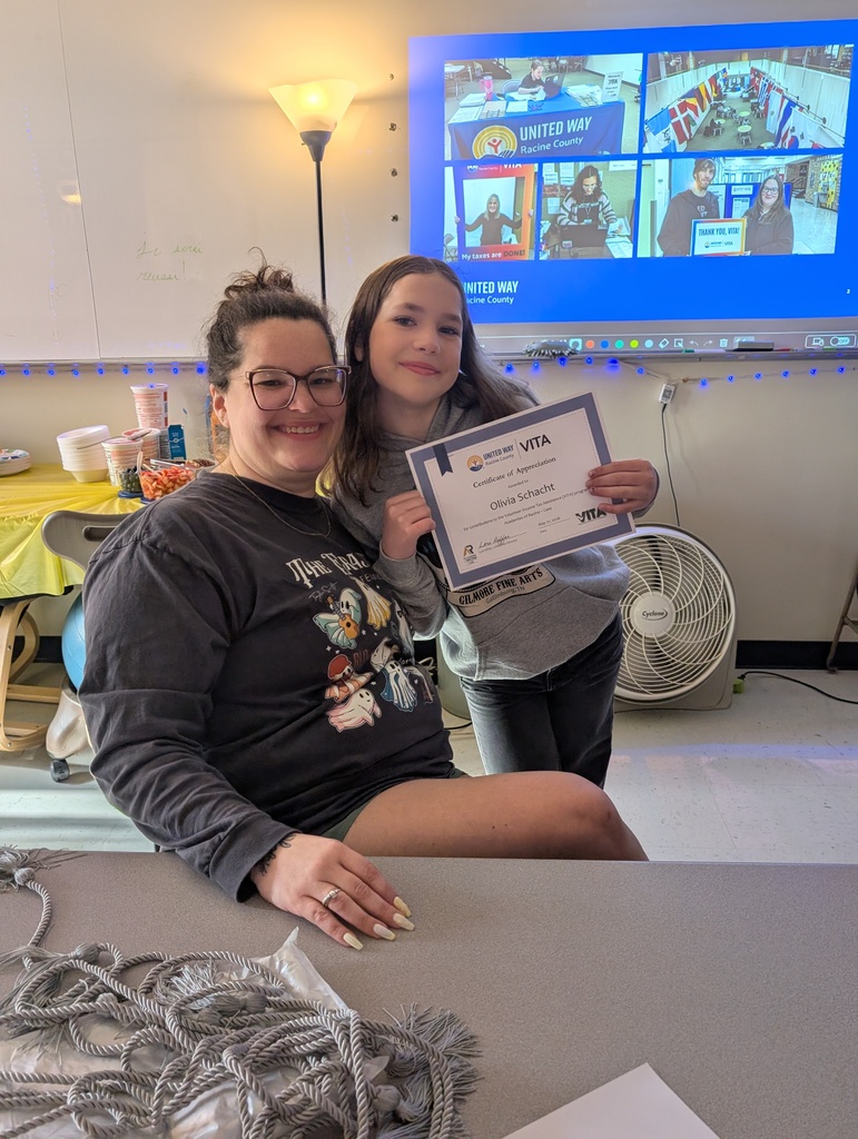 A female student and instructor pose for a photo at the VITA certificate ceremony.
