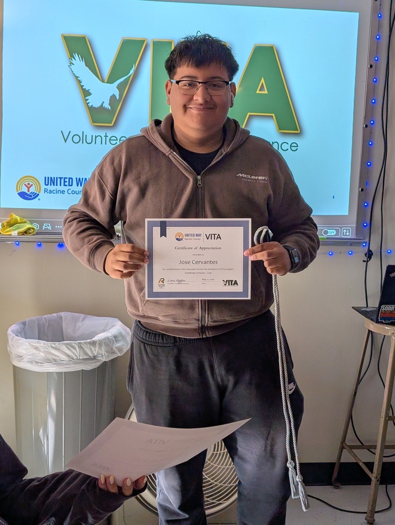 A make student posing for a photo with his VITA certificate.