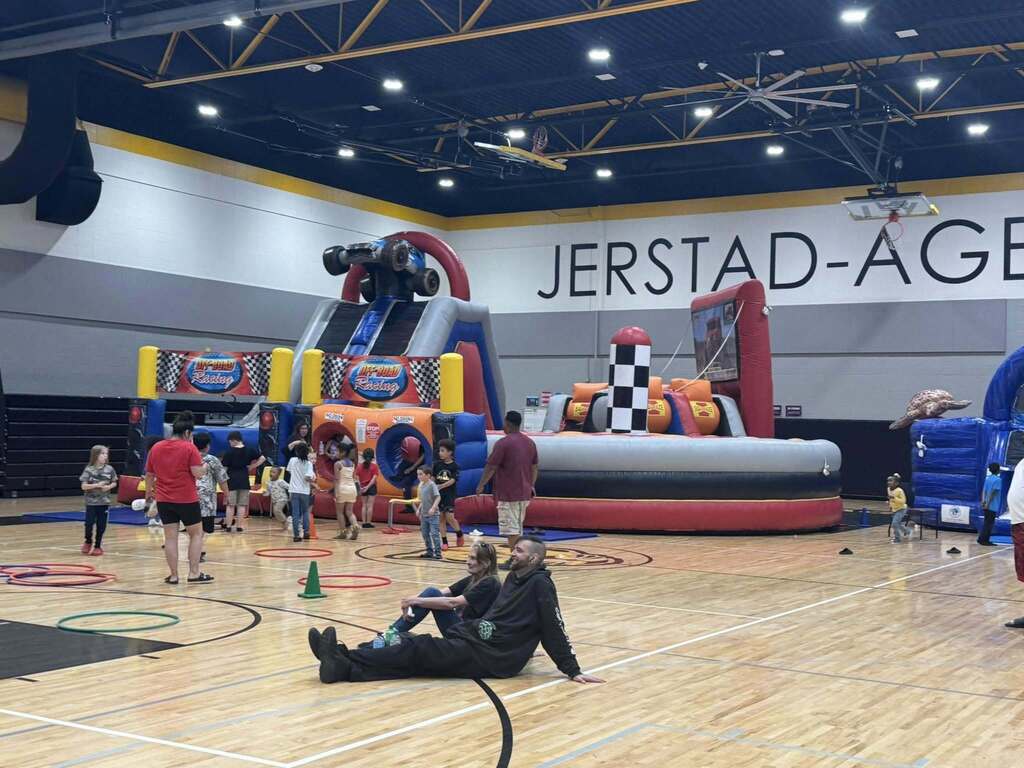 Students and their families play in the gym at the spring title night.