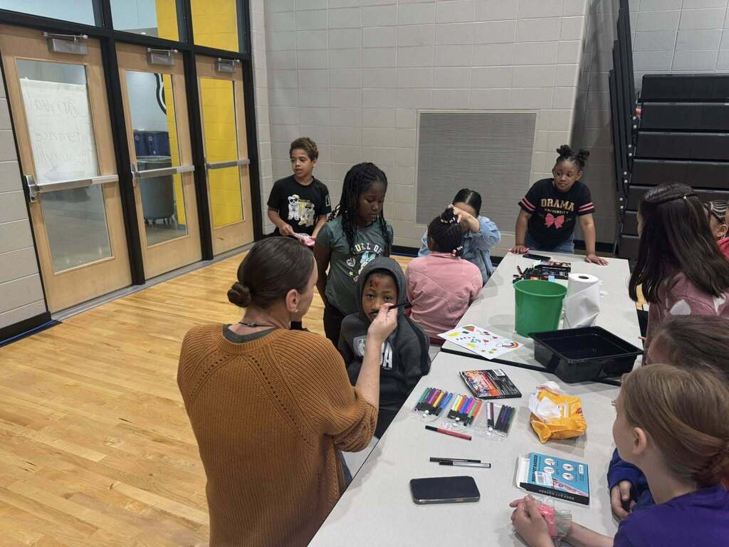 Students get their faces painted.