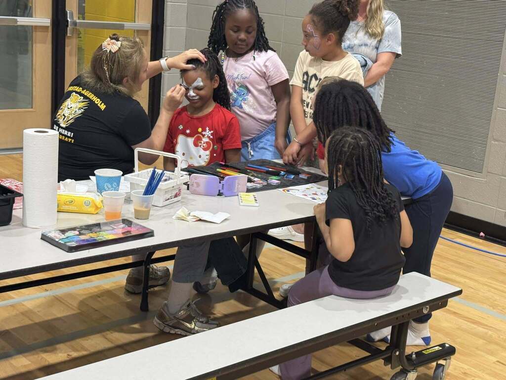 Students get their faces painted at the spring title night.