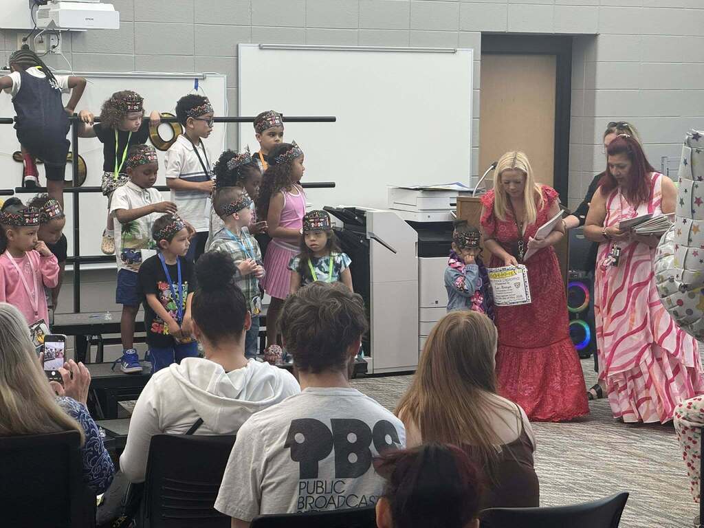 Ms. Hanyard giving a certificate to one of her students.