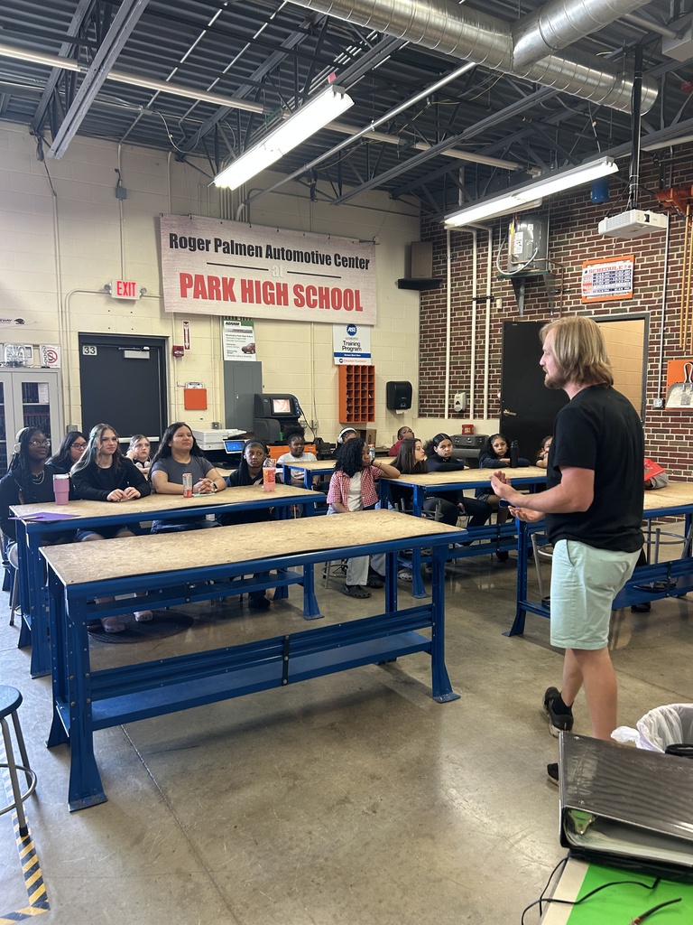 Students in Mitchell's STEM Girls class listinging to Park's automotive instructor.