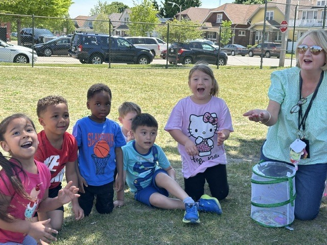 PreK students and teacher excited as butterflies take flight.