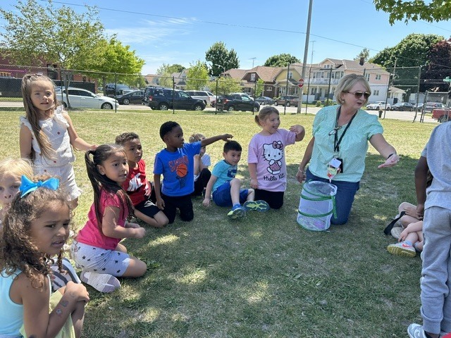 Teacher and students releasing butterflies.