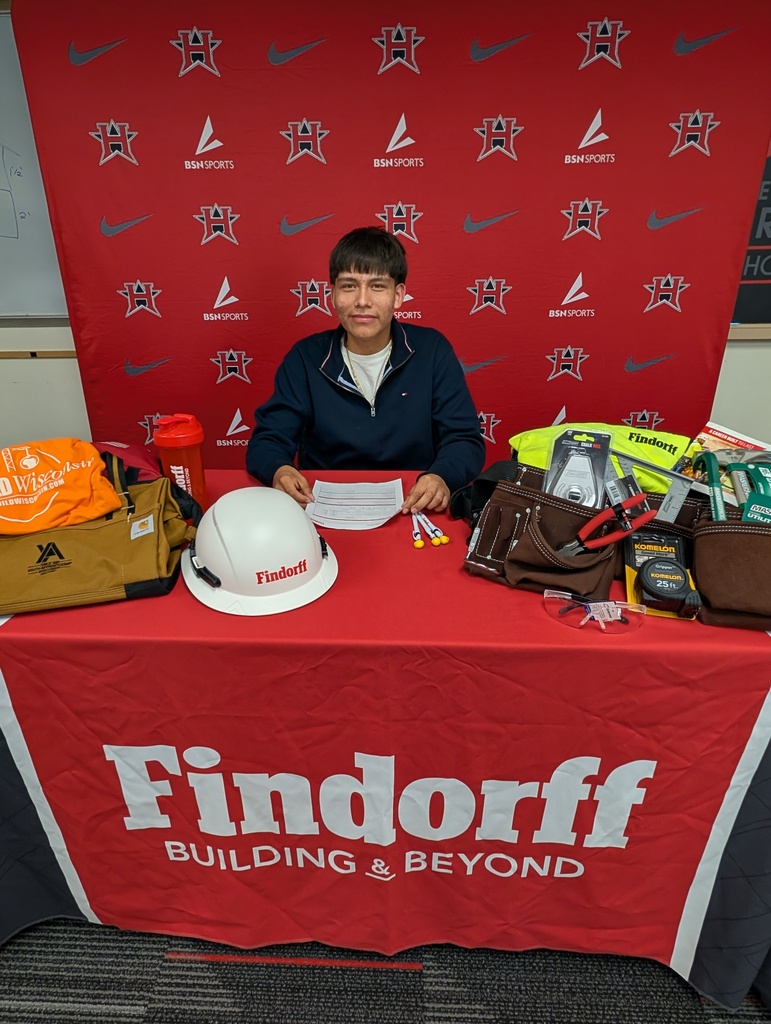 Juan posing for a photo at his signing ceremony.