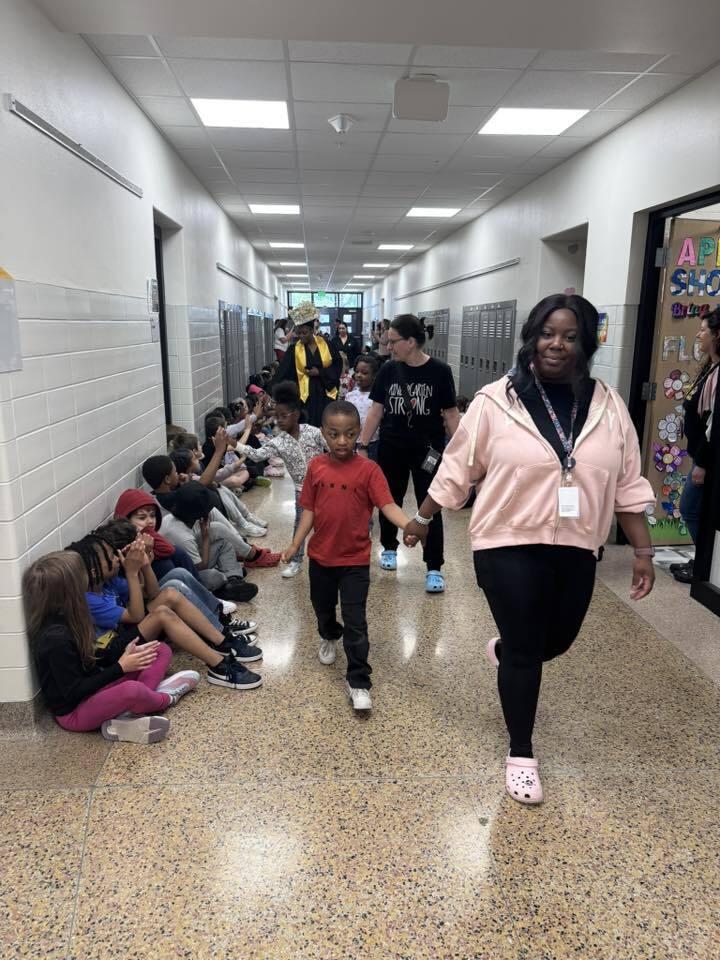 Our kindergarten students walk the halls with the seniors.